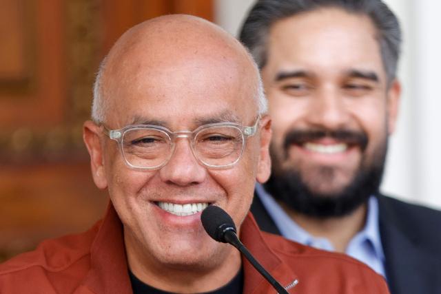 Venezuela's President of the National Assembly, Jorge Rodriguez (L), smiles next to Deputy Nicolas Maduro Guerra (R) during a press conference after a meeting with deputies at the National Assembly in Caracas on January 20, 2026. The Venezuelan Parliament announced on January 20 a comprehensive reform of the laws, amid a new political context following the overthrow of Nicolas Maduro by the United States. The "Chavismo" controls the National Assembly. Its president, Jorge Rodriguez, explained that the proposal includes the creation and reform of 29 laws. (Photo by Pedro MATTEY / AFP)