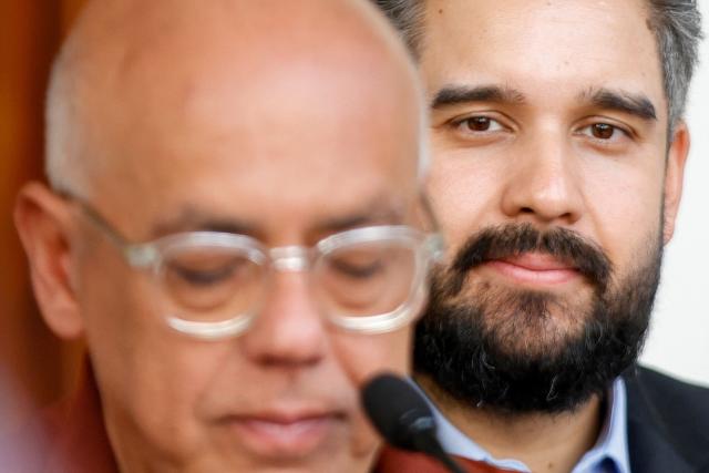 Venezuela's Deputy Nicolas Maduro Guerra (R) gestures next to President of the National Assembly, Jorge Rodriguez (L), during a press conference after a meeting with deputies at the National Assembly in Caracas on January 20, 2026. The Venezuelan Parliament announced on January 20 a comprehensive reform of the laws, amid a new political context following the overthrow of Nicolas Maduro by the United States. The "Chavismo" controls the National Assembly. Its president, Jorge Rodriguez, explained that the proposal includes the creation and reform of 29 laws. (Photo by Pedro MATTEY / AFP)