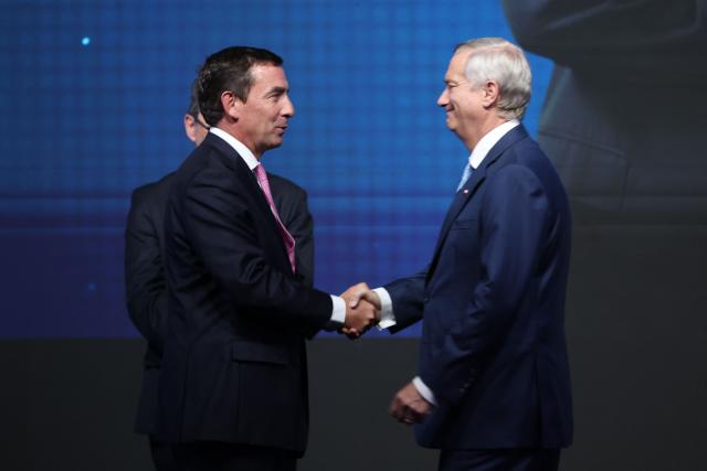 Chile's President-elect Jose Antonio Kast (R) greets Fernando Rabat as new Minister of Justice and Human Rights during the presentation of his cabinet at the office of the president-elect, commonly nicknamed 'La Moneda Chica,' in Las Condes, Santiago, on January 20, 2026. Chile's right-wing president-elect Jose Antonio Kast on january 20 named two ex-lawyers of former dictator Augusto Pinochet to lead the ministries of defense and human rights when he takes office in March. (Photo by Alvaro NARANJO / AFP)
