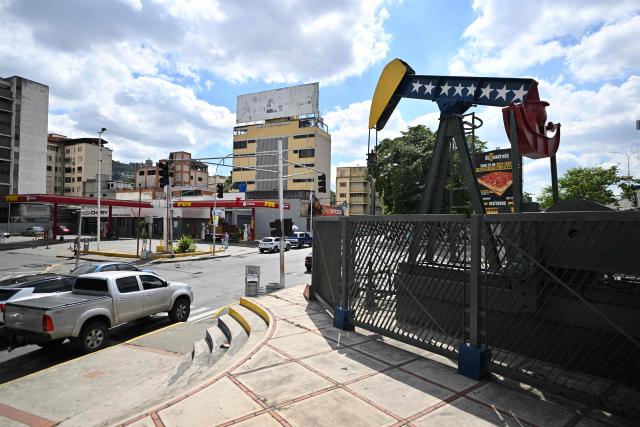 A pumpjack with the colors of the Venezuelan flag is seen on a street in Caracas on January 20, 2026. Venezuela's interim President Delcy Rodriguez said on January 20, 2025, that her country has received $300 million from a United States sale of Venezuelan crude and she will use it to prop up her country's battered currency, the bolivar. (Photo by Juan BARRETO / AFP)