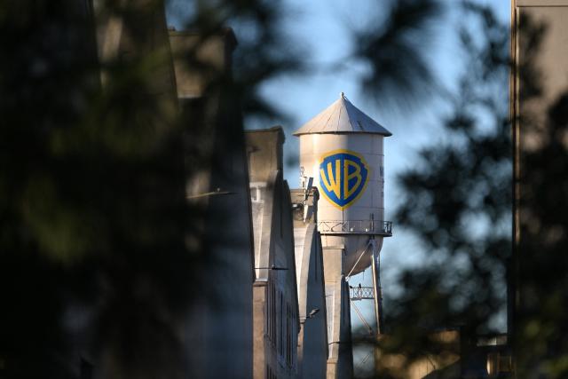 (FILES) The WB water tower is seen at Warner Bros. Studios in Burbank, California, on December 9, 2025. Netflix shares fell more than five percent on January 20 as the streaming entertainment giant said it expected revenue to be essentially flat in the current quarter after years of growth. The earnings report came as Netflix presses a bid to buy television and film titan Warner Brothers Discovery (WBD). (Photo by Robyn Beck / AFP)