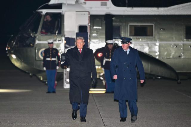 US President Donald Trump heads to board Air Force One before departing Joint Base Andrews in Maryland on January 20, 2026. Trump is heading to the Swiss ski resort of Davos to attend the World Economic Forum (WEF). (Photo by Mandel NGAN / AFP)