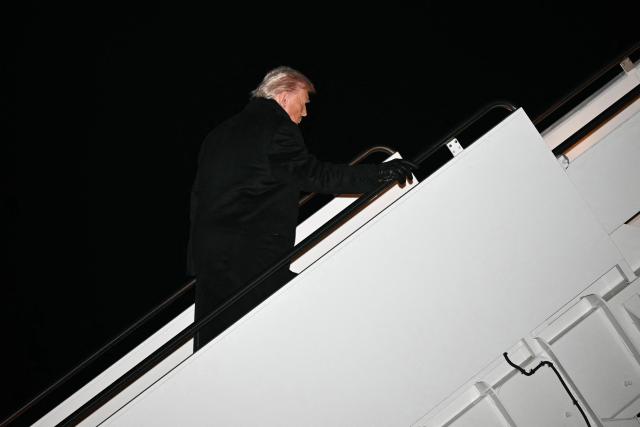 US President Donald Trump boards Air Force One before departing Joint Base Andrews in Maryland on January 20, 2026. Trump is heading to the Swiss ski resort of Davos to attend the World Economic Forum (WEF). (Photo by Mandel NGAN / AFP)