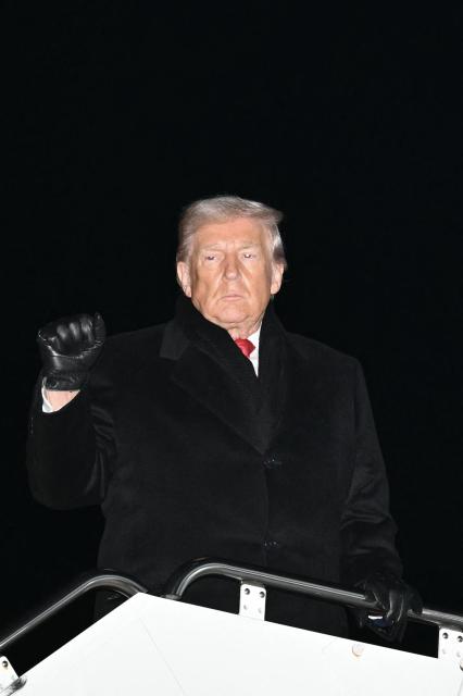 US President Donald Trump boards Air Force One before departing Joint Base Andrews in Maryland on January 20, 2026. Trump is heading to the Swiss ski resort of Davos to attend the World Economic Forum (WEF). (Photo by Mandel NGAN / AFP)