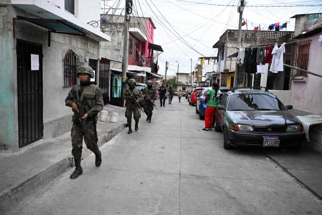Guatemalan Army soldiers patrol a street of the Nueva Jerusalen neighborhood during the state of emergency declared by the government in Guatemala City on January 20, 2026. Guatemalan soldiers began patrolling gang-controlled neighborhoods in the capital on Tuesday, after attacks that left ten police officers dead and prompted the government to declare a state of siege, according to official sources and an AFP journalist. (Photo by JOHAN ORDONEZ / AFP)