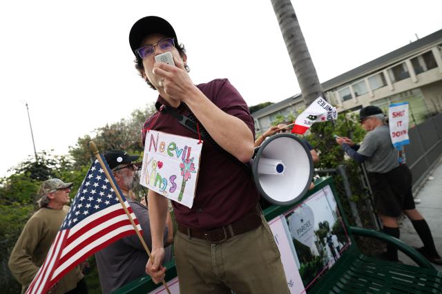 People take part in the Free America Walkout to protest against Immigration and Customs Enforcement (ICE) and US President Donald Trump's policies in the Venice Beach neighborhood of Los Angeles, California on January 20, 2026. (Photo by Patrick T. Fallon / AFP)