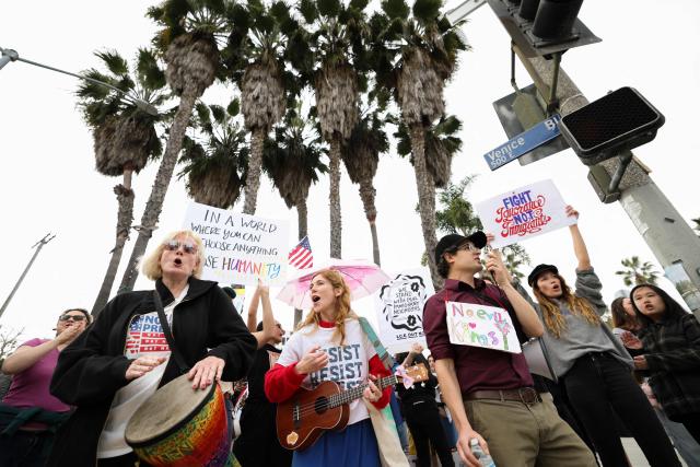 People take part in the Free America Walkout to protest against Immigration and Customs Enforcement (ICE) and US President Donald Trump's policies in the Venice Beach neighborhood of Los Angeles, California on January 20, 2026. (Photo by Patrick T. Fallon / AFP)
