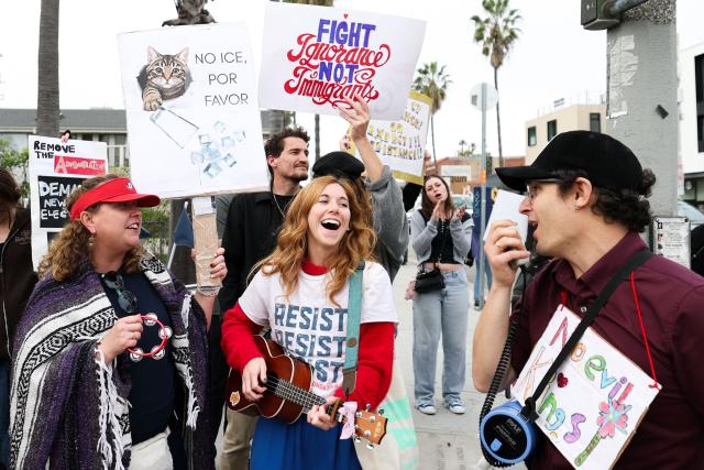 People take part in the Free America Walkout to protest against Immigration and Customs Enforcement (ICE) and US President Donald Trump's policies in the Venice Beach neighborhood of Los Angeles, California on January 20, 2026. (Photo by Patrick T. Fallon / AFP)