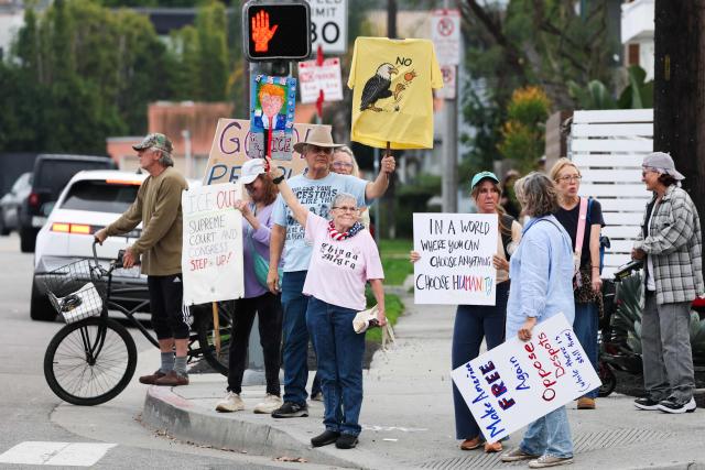 People take part in the Free America Walkout to protest against Immigration and Customs Enforcement (ICE) and US President Donald Trump's policies in the Venice Beach neighborhood of Los Angeles, California on January 20, 2026. (Photo by Patrick T. Fallon / AFP)