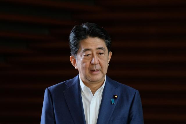 (FILES) This picture taken on August 24, 2020 shows Japan's Prime Minister Shinzo Abe making a short speech to the media upon his arrival at the prime minister's office in Tokyo. The gunman charged with killing Abe faces a verdict on January 21, 2026, more than three years after the broad-daylight assassination shocked the world. (Photo by Kazuhiro NOGI / AFP)