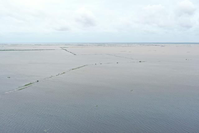 TOPSHOT - This aerial view shows floodwater caused by heavy rains near Maputo on January 20, 2026. At least 114 people have died since the rainy season began in early October 2025, including 51 since Christmas Eve, when downpours intensified and sent torrents of river water crashing through several villages.
The United Nations says the surging waters have spiralled into a rapidly escalating emergency. (Photo by Emidio JOZINE / AFP)