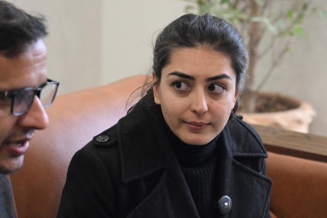 Human rights lawyer Imaan Mazari (R) sits with a journalist, after a hearing at the Islamabad High Court Bar Association in Islamabad on January 20, 2026. (Photo by Aamir QURESHI / AFP)