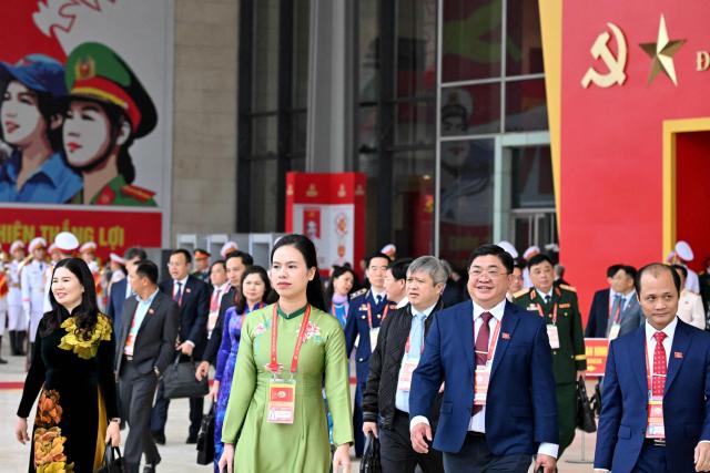 Delegates leave the meeting room at the National Convention Centre, where the 14th National Congress of the Communist Party of Vietnam is being held, in Hanoi on January 21, 2026. (Photo by Nhac NGUYEN / AFP)