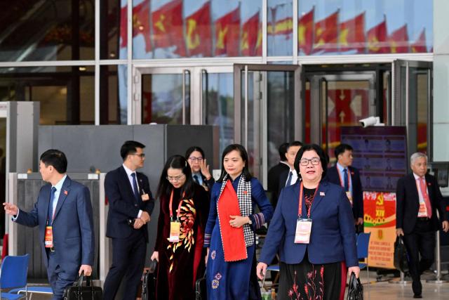 Delegates leave the meeting room at the National Convention Centre, where the 14th National Congress of the Communist Party of Vietnam is being held, in Hanoi on January 21, 2026. (Photo by Nhac NGUYEN / AFP)