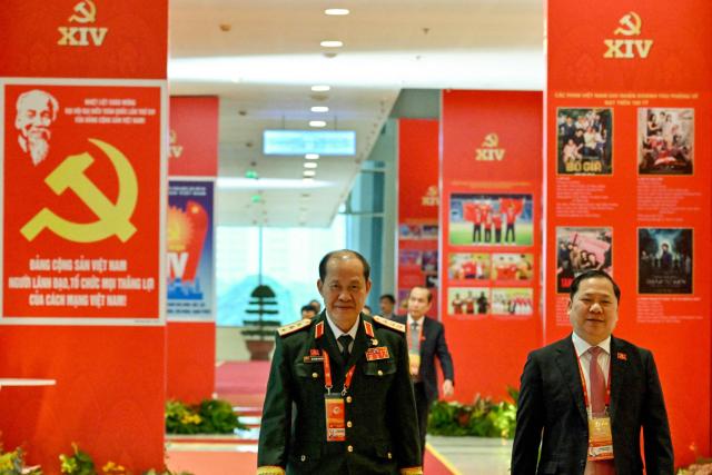 Delegates arrive to attend the meeting of the 14th National Congress of the Communist Party of Vietnam at the National Convention Centre in Hanoi on January 21,2026. (Photo by Nhac NGUYEN / AFP)