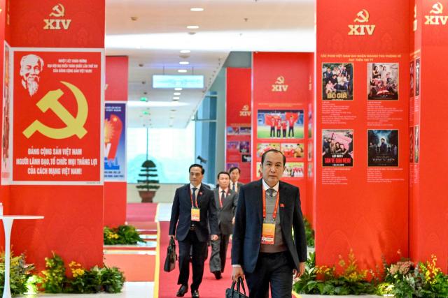 Delegates arrive to attend the meeting of the 14th National Congress of the Communist Party of Vietnam at the National Convention Centre in Hanoi on January 21,2026. (Photo by Nhac NGUYEN / AFP)