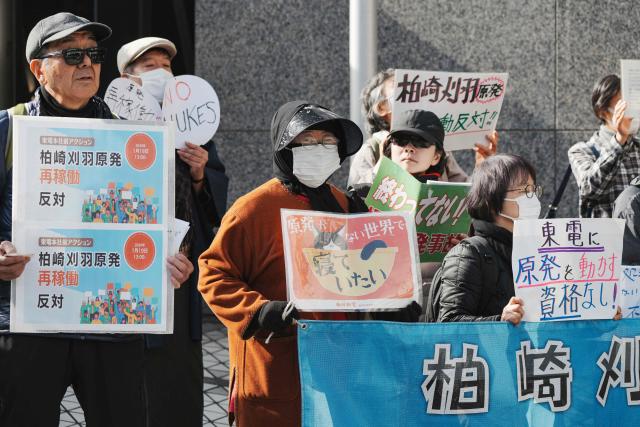 Participants demonstrate in front of the Tokyo Electric Power Company's headquarters, against the restart of the Kashiwazaki-Kariwa Nuclear Power Plant, in Tokyo on January 19, 2026. The world's biggest nuclear power plant is set to restart on January 21 for the first time since the 2011 Fukushima disaster, its Japanese operator said, despite persistent safety concerns among residents. (Photo by Kazuhiro NOGI / AFP)