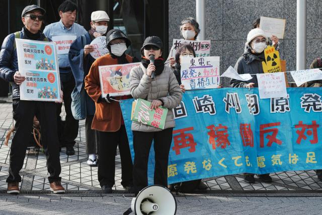 Participants demonstrate in front of the Tokyo Electric Power Company's headquarters, against the restart of the Kashiwazaki-Kariwa Nuclear Power Plant, in Tokyo on January 19, 2026. The world's biggest nuclear power plant is set to restart on January 21 for the first time since the 2011 Fukushima disaster, its Japanese operator said, despite persistent safety concerns among residents. (Photo by Kazuhiro NOGI / AFP)