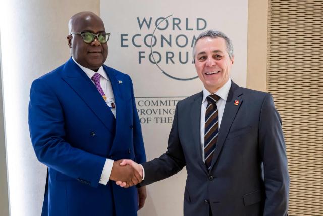 President of the Democratic Republic of Congo Felix Tshisekedi (L) shakes hands with Member of the Swiss Federal Council Ignazio Cassis prior to a bilateral meeting on the sidelines of the 56th annual meeting of the World Economic Forum (WEF) in Davos, Switzerland, on January 21, 2026. The World Economic Forum takes place in Davos from January 19 to January 23, 2026. (Photo by LAURENT GILLIERON / POOL / AFP)