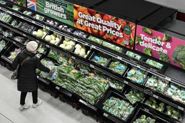 (FILES) A customer shops in the fresh vegetable aisle at a supermarket in southwest London on December 17, 2025. Britain's annual inflation rate rose more than expected in December, official data showed on January 21, 2026, reinforcing expectations that the Bank of England will hold off on cutting interest rates next month. (Photo by JUSTIN TALLIS / AFP)