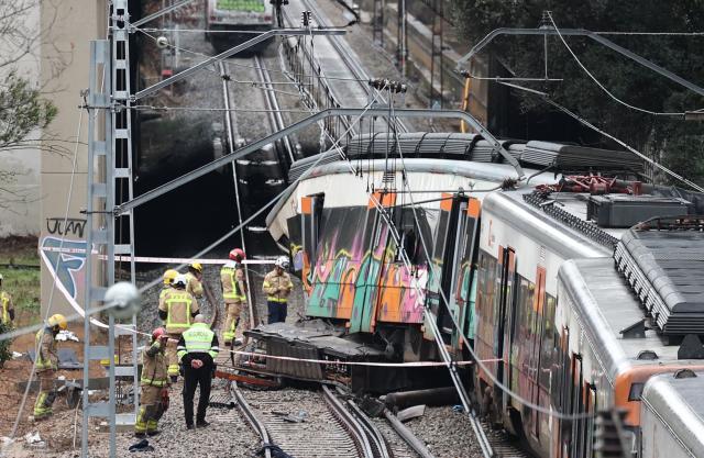 Firefighters work at the site where at least one person died and five were seriously injured when a regional service train collided with a collapsed wall  between Sant Sadurni d'Anoia and Gelida, near Barcelona, on January 21, 2026. The latest incident is likely to raise more questions about Spanish rail safety after the collision of two high-speed trains in the southern region of Andalusia on Sunday killed 42 people and injured more than 120.  (Photo by Josep LAGO / AFP)