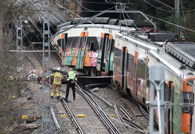 Firefighters work at the site where at least one person died and five were seriously injured when a regional service train collided with a collapsed wall  between Sant Sadurni d'Anoia and Gelida, near Barcelona, on January 21, 2026. The latest incident is likely to raise more questions about Spanish rail safety after the collision of two high-speed trains in the southern region of Andalusia on Sunday killed 42 people and injured more than 120.  (Photo by Josep LAGO / AFP)