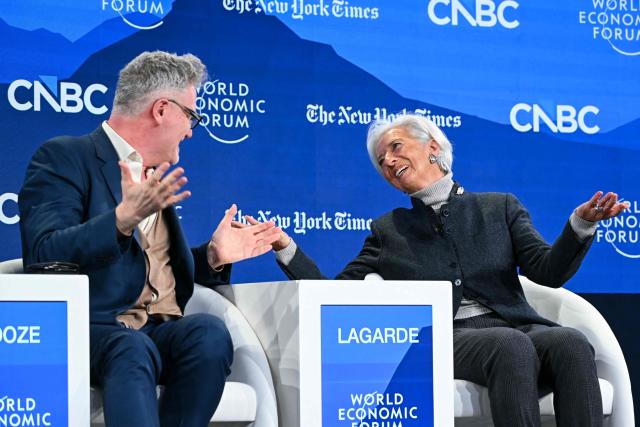 European Central Bank (ECB) president Christine Lagarde (R) speaks with British-US historian Adam Tooze during the World Economic Forum (WEF) annual meeting in Davos on January 21, 2026. The World Economic Forum takes place in Davos from January 19 to January 23, 2026. (Photo by Fabrice COFFRINI / AFP)