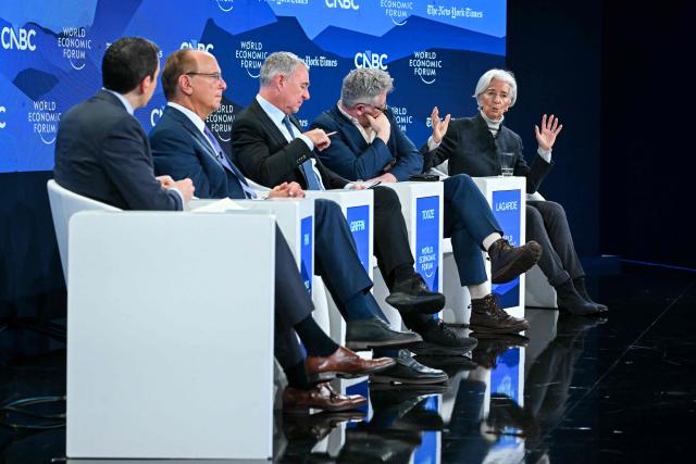 European Central Bank (ECB) president Christine Lagarde (R) speaks during the World Economic Forum (WEF) annual meeting in Davos on January 21, 2026. The World Economic Forum takes place in Davos from January 19 to January 23, 2026. (Photo by Fabrice COFFRINI / AFP)