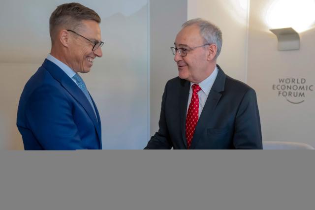Finland's President Alexander Stubb (L) and Switzerland's Federal President Guy Parmelin shake hands during a bi-lateral meeting on the sidelines of the 56th annual meeting of the World Economic Forum (WEF) annual meeting in Davos on January 21, 2026. The World Economic Forum is taking place in Davos from January 19 to January 23, 2026. (Photo by LAURENT GILLIERON / POOL / AFP)