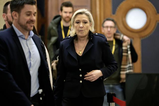 President of the parliamentary group of the French far-right Rassemblement National (RN) party, Marine Le Pen leaves during a break during her appeal trial on charges of embezzlement of European public funds in a case of alleged European Parliament fake jobs in Paris the Palais de Justice de Paris on January 21, 2026. Le Pen is called to the stand in the appeal trial in Paris of the parliamentary assistants of the National Front, where she is playing for her candidacy for the 2027 presidential election. Twelve of the accused, as well as the far-right party itself, have appealed against the verdict while another 12 people -- including one of Le Pen's sisters -- have decided to accept their convictions without appealing. (Photo by STEPHANE DE SAKUTIN / AFP)