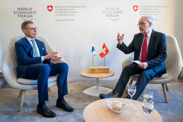 Finland's President Alexander Stubb (L) and Switzerland's Federal President Guy Parmelin shake hands during a bi-lateral meeting on the sidelines of the 56th annual meeting of the World Economic Forum (WEF) annual meeting in Davos on January 21, 2026. The World Economic Forum is taking place in Davos from January 19 to January 23, 2026. (Photo by LAURENT GILLIERON / POOL / AFP)