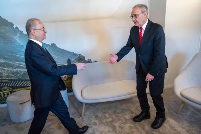 Palestinian Prime Minister Mohammad Mustafa (L) and Switzerland's Federal President Guy Parmelin shake hands during a bi-lateral meeting on the sidelines of the 56th annual meeting of the World Economic Forum (WEF) annual meeting in Davos on January 21, 2026. The World Economic Forum is taking place in Davos from January 19 to January 23, 2026. (Photo by LAURENT GILLIERON / POOL / AFP)