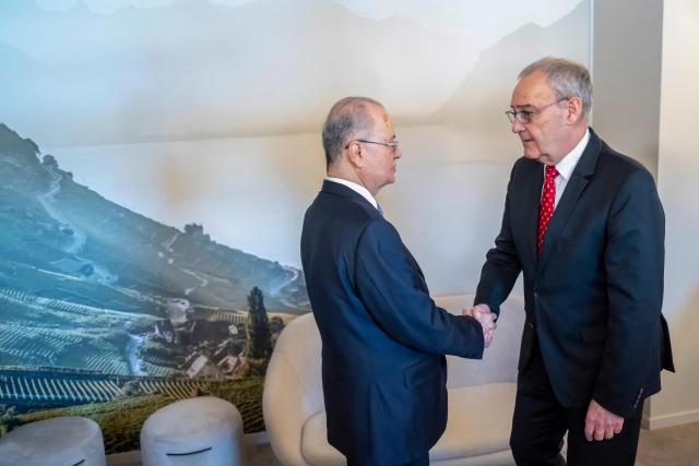 Palestinian Prime Minister Mohammad Mustafa (L) and Switzerland's Federal President Guy Parmelin shake hands during a bi-lateral meeting on the sidelines of the 56th annual meeting of the World Economic Forum (WEF) annual meeting in Davos on January 21, 2026. The World Economic Forum is taking place in Davos from January 19 to January 23, 2026. (Photo by LAURENT GILLIERON / POOL / AFP)