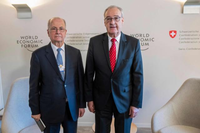 Palestinian Prime Minister Mohammad Mustafa (L) and Switzerland's Federal President Guy Parmelin shake hands during a bi-lateral meeting on the sidelines of the 56th annual meeting of the World Economic Forum (WEF) annual meeting in Davos on January 21, 2026. The World Economic Forum is taking place in Davos from January 19 to January 23, 2026. (Photo by LAURENT GILLIERON / POOL / AFP)