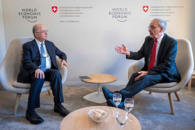 Palestinian Prime Minister Mohammad Mustafa (L) and Switzerland's Federal President Guy Parmelin shake hands during a bi-lateral meeting on the sidelines of the 56th annual meeting of the World Economic Forum (WEF) annual meeting in Davos on January 21, 2026. The World Economic Forum is taking place in Davos from January 19 to January 23, 2026. (Photo by LAURENT GILLIERON / POOL / AFP)