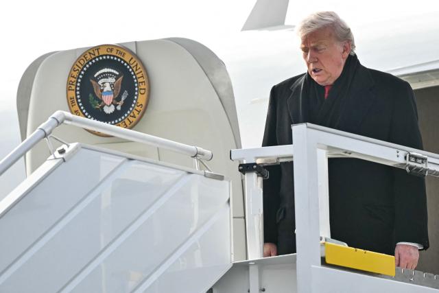 US President Donald Trump steps off Air Force One upon arrival at Zurich Airport on January 21, 2026. The World Economic Forum takes place in Davos from January 19 to January 23, 2026. (Photo by Mandel NGAN / AFP)