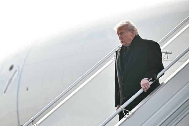 US President Donald Trump steps off Air Force One upon arrival at Zurich Airport on January 21, 2026. The World Economic Forum takes place in Davos from January 19 to January 23, 2026. (Photo by Mandel NGAN / AFP)