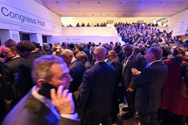 Visitors queue to enter the Congress hall to attend US President's special address during the World Economic Forum (WEF) annual meeting in Davos on January 21, 2026. The World Economic Forum takes place in Davos from January 19 to January 23, 2026. (Photo by Fabrice COFFRINI / AFP)