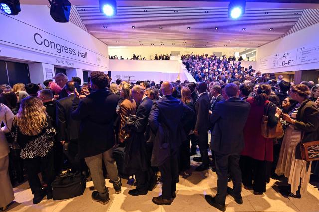 Visitors queue to enter the Congress hall to attend US President's special address during the World Economic Forum (WEF) annual meeting in Davos on January 21, 2026. The World Economic Forum takes place in Davos from January 19 to January 23, 2026. (Photo by Fabrice COFFRINI / AFP)