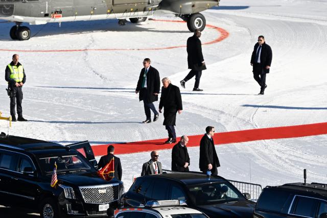 US President Donald Trump (C) arrives to board a car after stepping out of Marine One helicopter at Davos Landing Zone in Davos prior to attend the World Economic Forum (WEF) annual meeting on January 21, 2026. The World Economic Forum takes place in Davos from January 19 to January 23, 2026. (Photo by INA FASSBENDER / AFP)