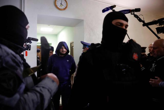 Akhmadzhon Kurbonov, charged with the December 2024 killing of the Russian army's chemical weapons division head, Lieutenant General Igor Kirillov, appears in court for the verdict announcement, in Moscow on January 21, 2026. (Photo by TATYANA MAKEYEVA / AFP)