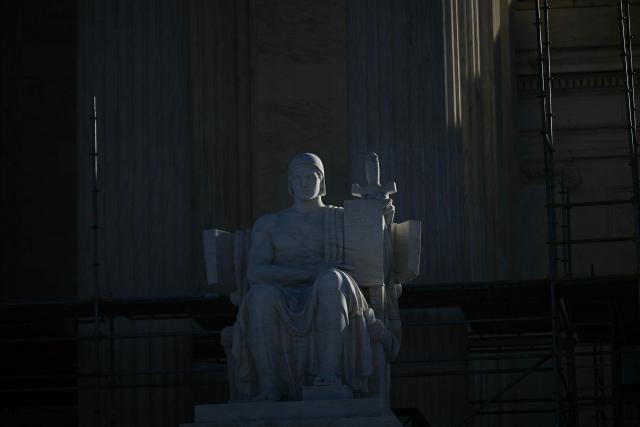 A statue is seen outside the US Supreme Court in Washington, DC, on January 21, 2026. The US Supreme Court hears arguments on Wednesday over President Donald Trump's attempt to fire a Federal Reserve governor, a case which could have far-reaching consequences for the independence of the central bank. (Photo by Brendan SMIALOWSKI / AFP)
