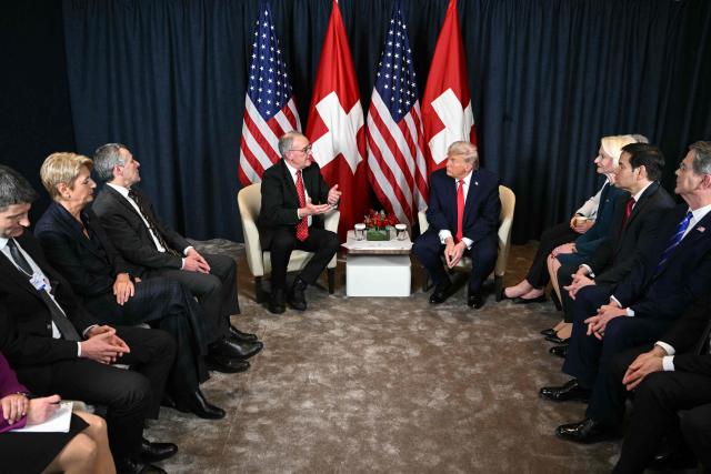US President Donald Trump (C-R) attends a bilateral meeting with Switzerland's President Guy Parmelin (C-L) on the sidelines of the World Economic Forum (WEF) annual meeting in Davos on January 21, 2026. The World Economic Forum takes place in Davos from January 19 to January 23, 2026. (Photo by Mandel NGAN / AFP)
