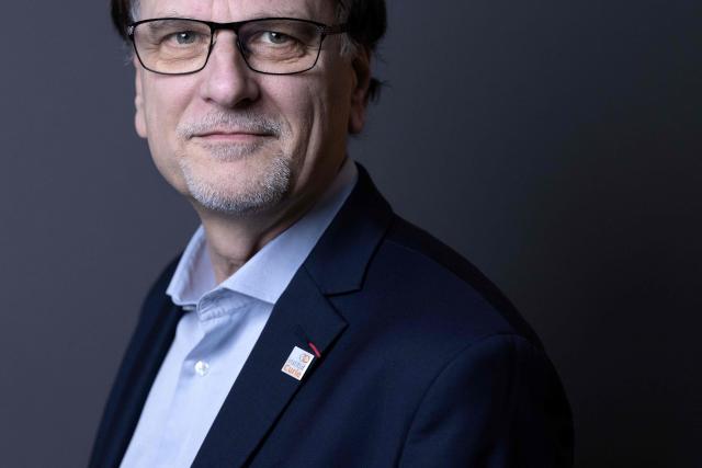 French pharmacist, biologist and Director of Institut Curie's Research Center Alain Puisieux, poses for photographs during a portrait session in his office, in Paris, on January 21, 2026. (Photo by JOEL SAGET / AFP)