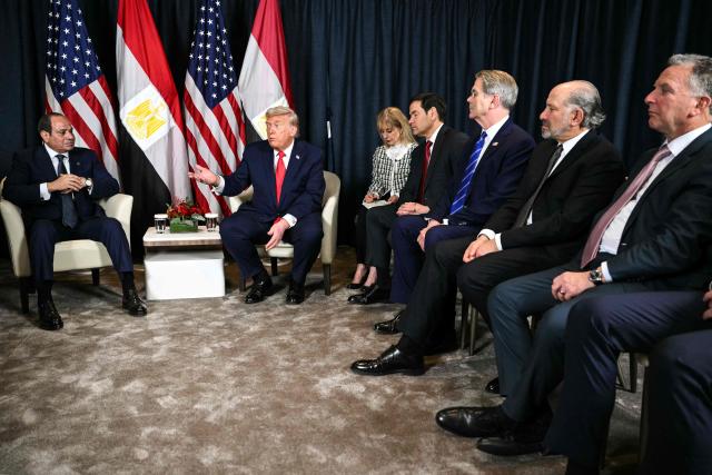 US President Donald Trump (C) speaks with Egypt's President Abdel Fattah al-Sissi (L) next to US Secretary of State Marco Rubio (4R), US Secretary of Treasury Scott Bessent (3R), US Secretary of Commerce Howard Lutnick (2R) and US Special Envoy Steve Witkoff during a bilateral meeting on the sidelines of the World Economic Forum (WEF) annual meeting in Davos on January 21, 2026. The World Economic Forum takes place in Davos from January 19 to January 23, 2026. (Photo by Mandel NGAN / AFP)