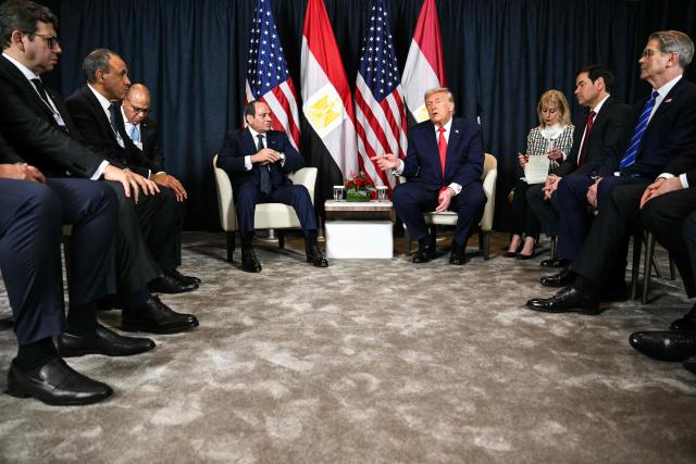 US President Donald Trump (C-R) speaks with Egypt's President Abdel Fattah al-Sissi (C-L) next to US Secretary of State Marco Rubio (2R) and US Secretary of Treasury Scott Bessent (R) during a bilateral meeting on the sidelines of the World Economic Forum (WEF) annual meeting in Davos on January 21, 2026. The World Economic Forum takes place in Davos from January 19 to January 23, 2026. (Photo by Mandel NGAN / AFP)