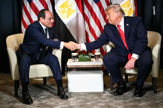 TOPSHOT - US President Donald Trump (R) shakes hands with Egypt's President Abdel Fattah al-Sissi during a bilateral meeting on the sidelines of the World Economic Forum (WEF) annual meeting in Davos on January 21, 2026. The World Economic Forum takes place in Davos from January 19 to January 23, 2026. (Photo by Mandel NGAN / AFP)