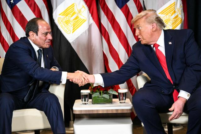 US President Donald Trump (R) shakes hands with Egypt's President Abdel Fattah al-Sissi during a bilateral meeting on the sidelines of the World Economic Forum (WEF) annual meeting in Davos on January 21, 2026. The World Economic Forum takes place in Davos from January 19 to January 23, 2026. (Photo by Mandel NGAN / AFP)