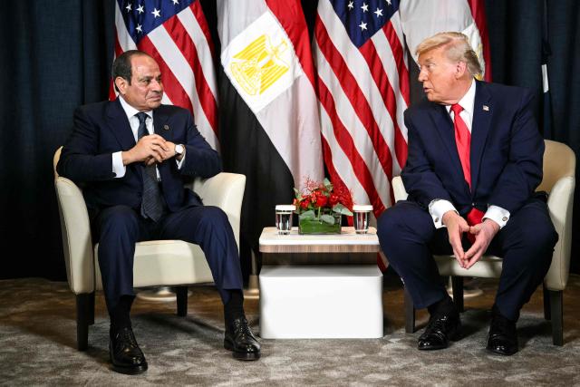US President Donald Trump (R) speaks with Egypt's President Abdel Fattah al-Sissi during a bilateral meeting on the sidelines of the World Economic Forum (WEF) annual meeting in Davos on January 21, 2026. The World Economic Forum takes place in Davos from January 19 to January 23, 2026. (Photo by Mandel NGAN / AFP)