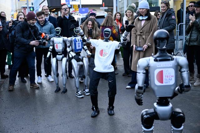 A photograph taken on January 21, 2026 shows Unitree G1 Robotic Humanoid models walking in the street of the Alpine resort of Davos during the World Economic Forum (WEF) annual meeting. The World Economic Forum takes place in Davos from January 19 to January 23, 2026. (Photo by INA FASSBENDER / AFP)